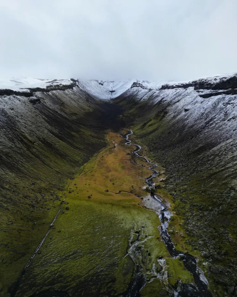 Aerial view of the vast Eldgjá Canyon, with dramatic cliffs and green grass covering the landscape, Iceland