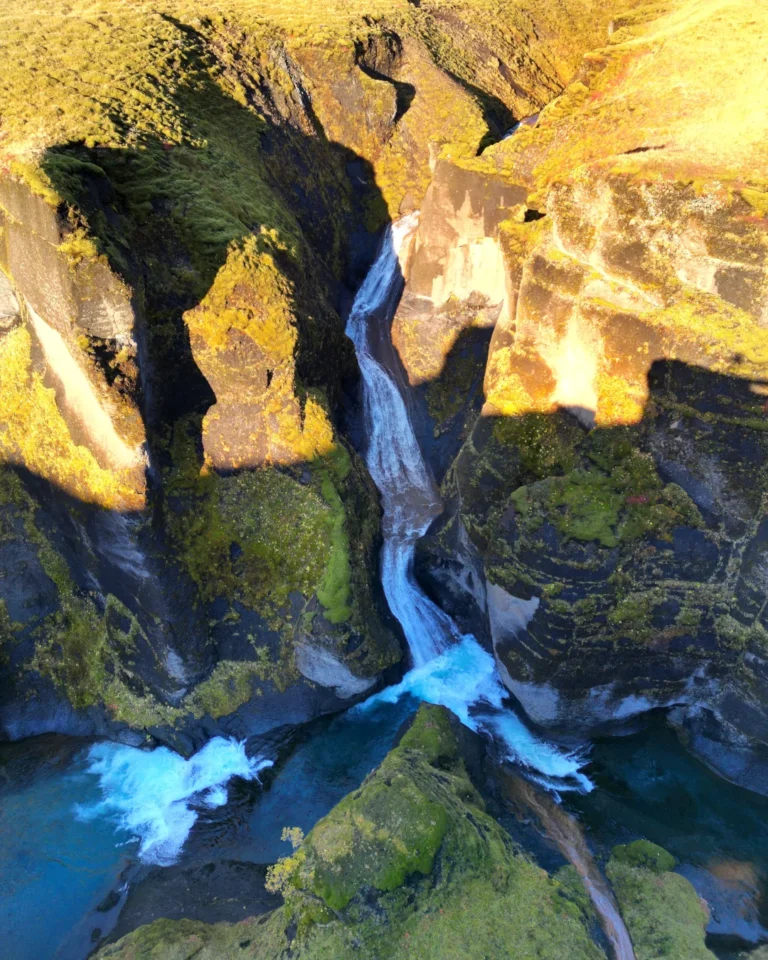 Waterfall shot of Fjaðrárgljúfur Canyon showing the winding river and dramatic canyon walls, Iceland