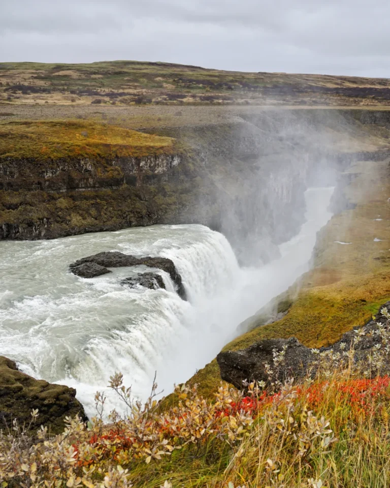 Gullfoss waterfall in autumn, surrounded by brown grass and heavy mist, Iceland