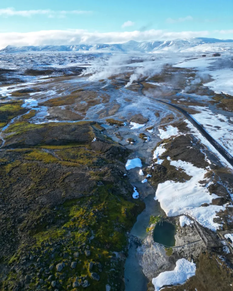 A smoky geothermal area at Hveravellir in Iceland, with steam rising into the air