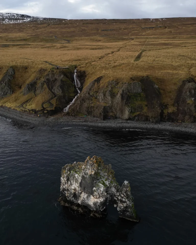 Aerial view of Hvítserkur rock formation with the cliff in the background, Iceland