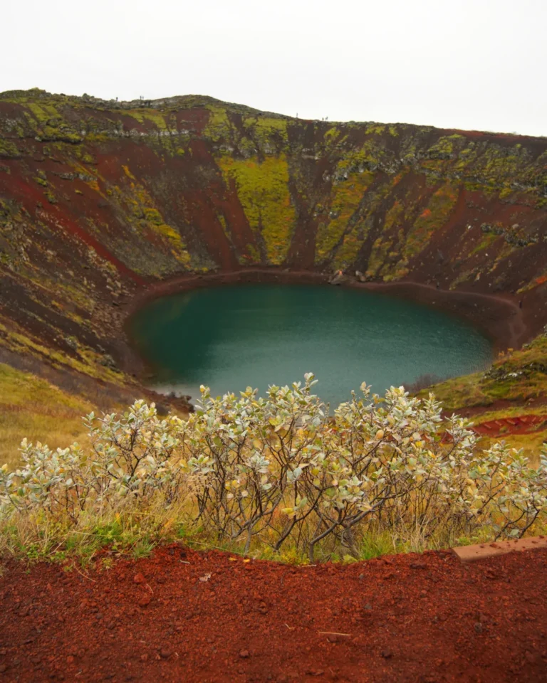 Kerid volcanic crater with striking red slopes and a vivid blue lake in Iceland