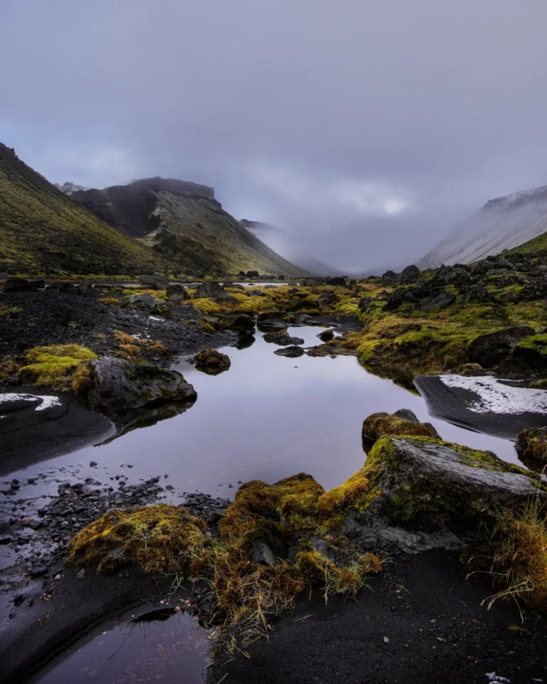 A serene pond reflecting the surrounding landscape in Eldgjá Canyon, Iceland