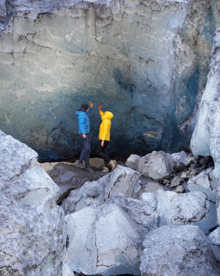 Us standing in front of a massive ice block at the Vatnajökull Glacier tongue, Iceland