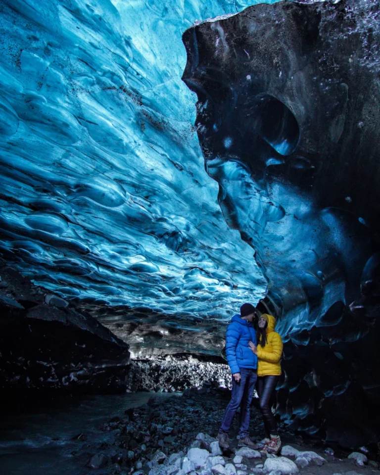 Stunning view inside an ice cave at Vatnajökull Glacier, with vibrant blue ice covering the walls and ceiling, Iceland