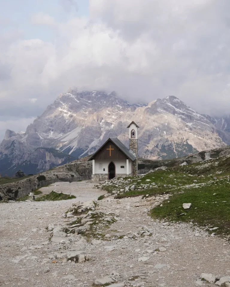 Small alpine chapel in front of the Tre Cime di Lavaredo peaks in the Sesto Dolomites.