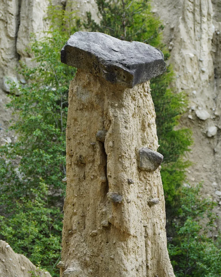 Nahaufnahme einer Erdpyramide in Percha mit einem großen Deckstein (Stein-Pilz).