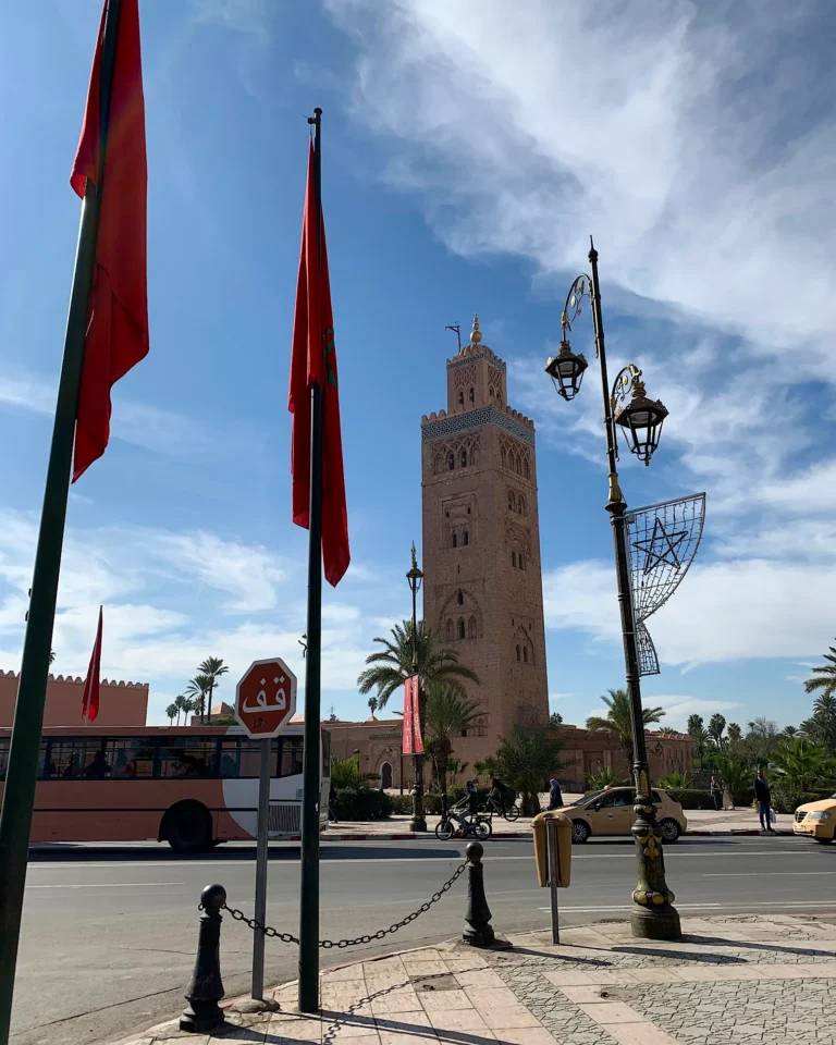Koutoubia Mosque in Marrakech with 2 red flags.