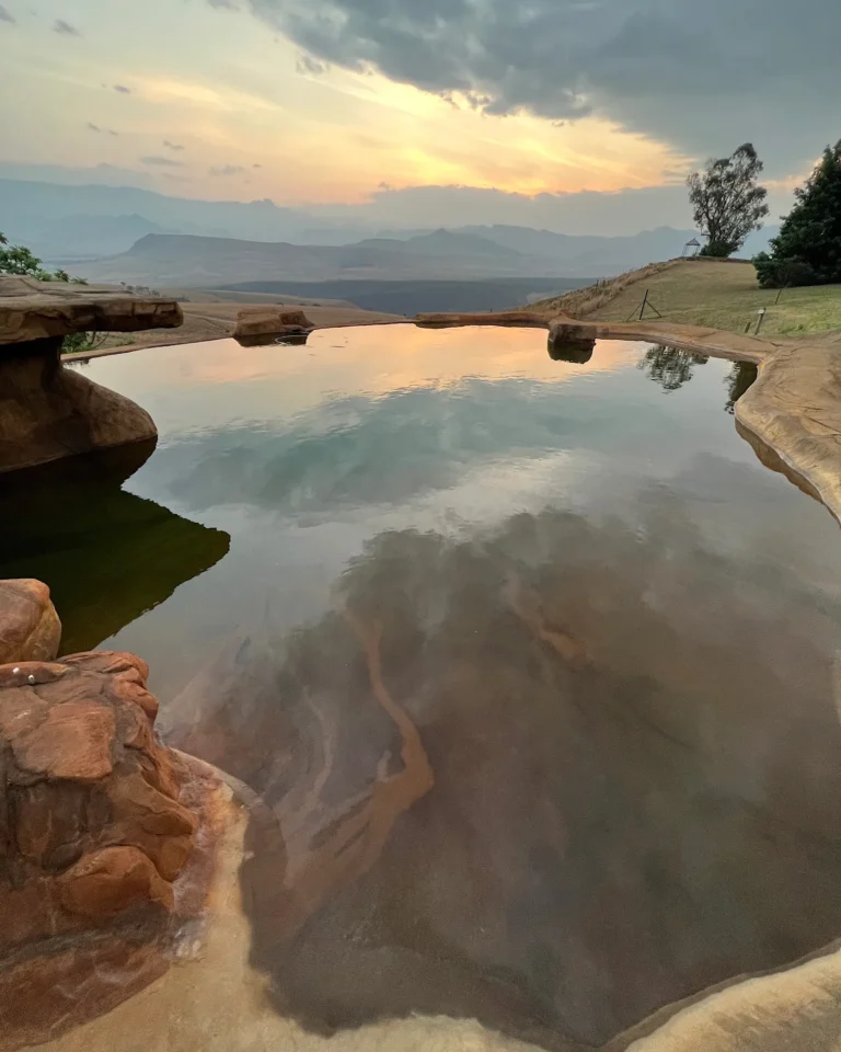 A long, naturally designed pool at sunset in the Drakensberg (Berghouse and Cottages).