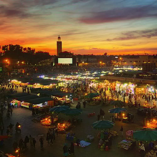 Djemaa el Fna at night with Koutoubia Mosque in the background.