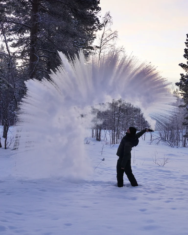 Spectacular ice crystal cloud during the boiling water challenge in wintery Lapland at -28 degree.