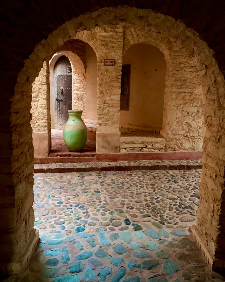 Large green vase under a stone arch in the Medina d'Agadir.