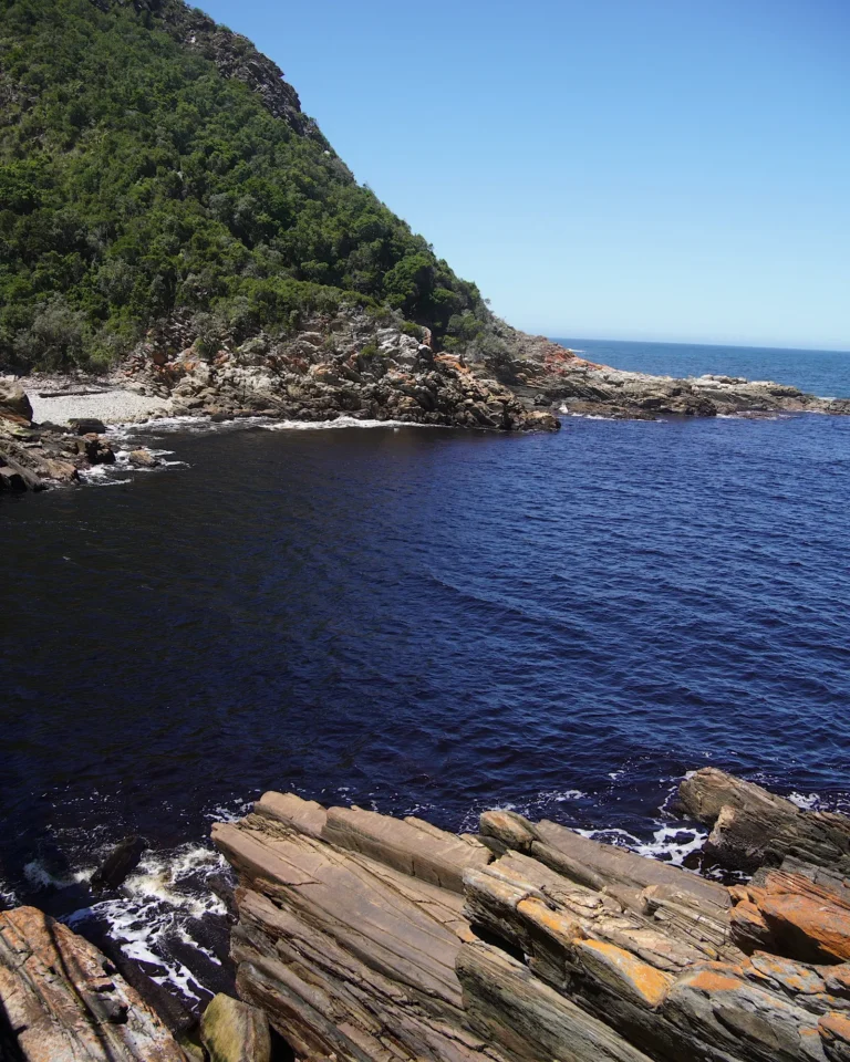 View of the ocean water between two rocky sections in Tsitsikamma National Park.