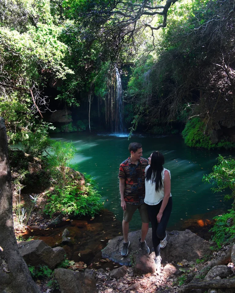 A couple enjoying the picturesque Tufa waterfall and pool in the Blyde River Canyon.