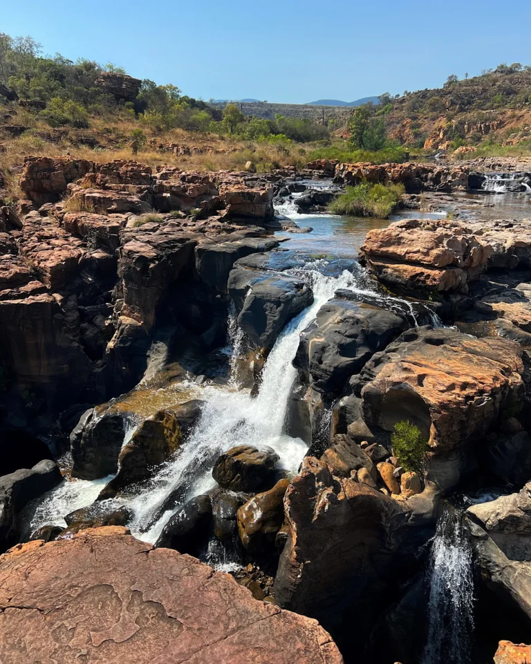 Small waterfall flowing into the rock formations of Bourke's Luck Potholes.