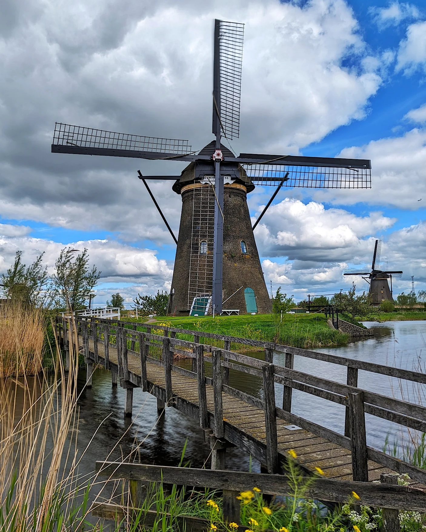 Historic windmill in Kinderdijk Netherlands with a clear blue sky.