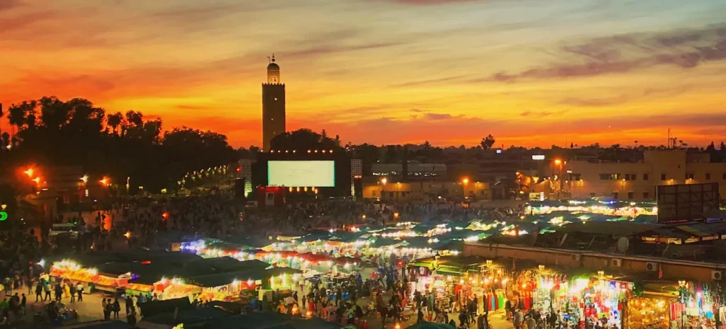 Djemaa el Fna at night with Koutoubia Mosque in the background.