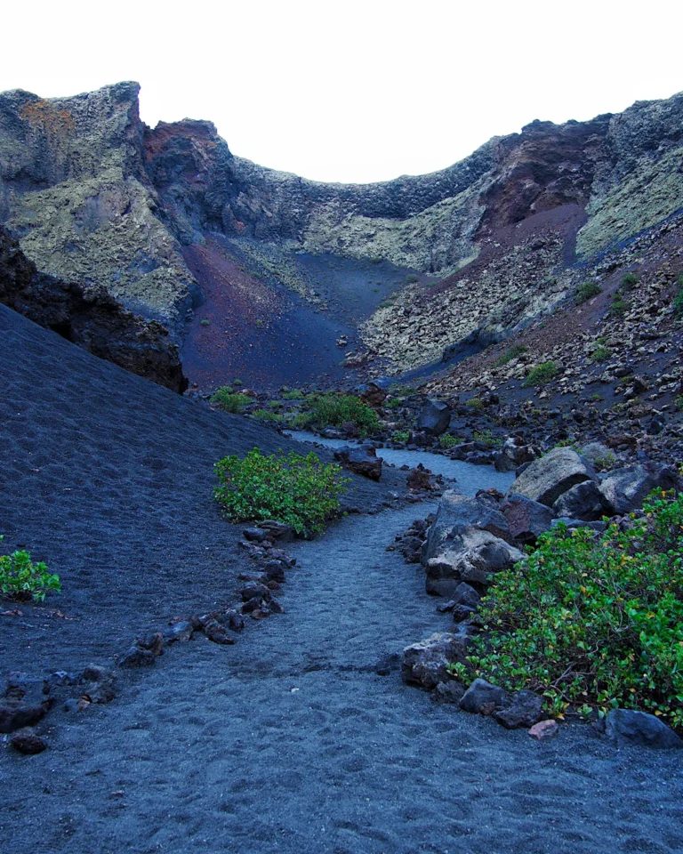 Hiking trail through the impressive volcanic landscape of Caldera de los Cuervos in Lanzarote.