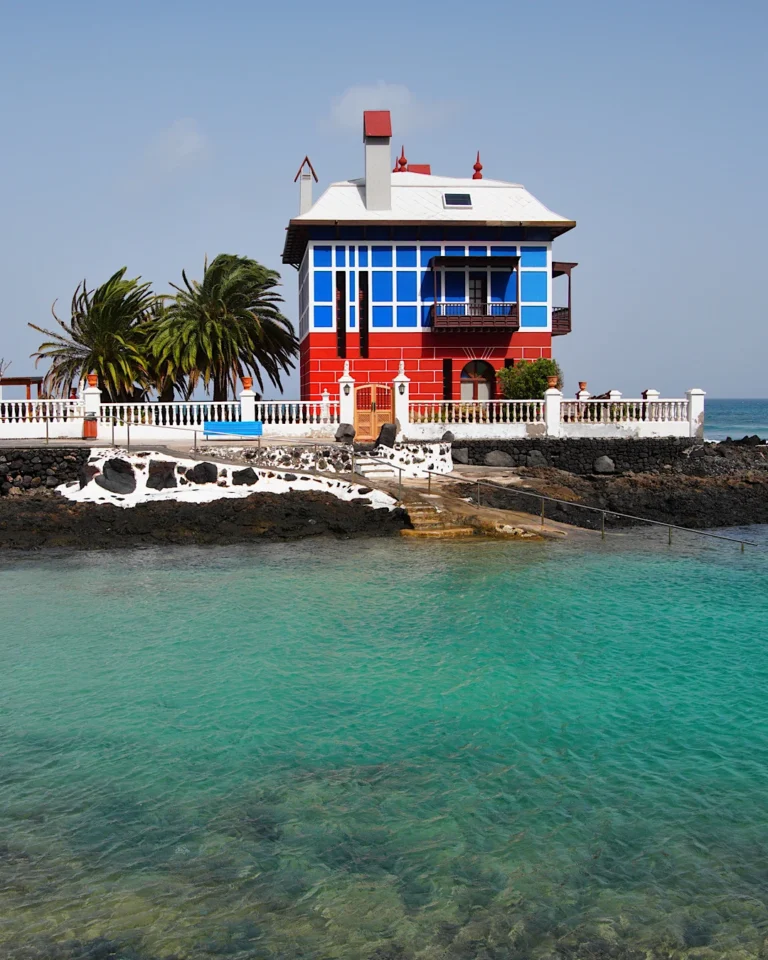 The famous blue and red house "Casa Juanita" by the sea in Arrieta, Lanzarote.