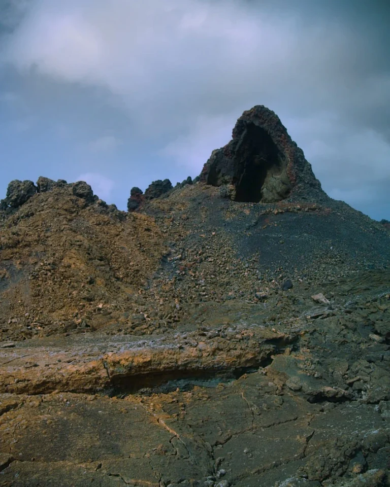View into a deep, dark volcanic crater in the lava landscape of Lanzarote.